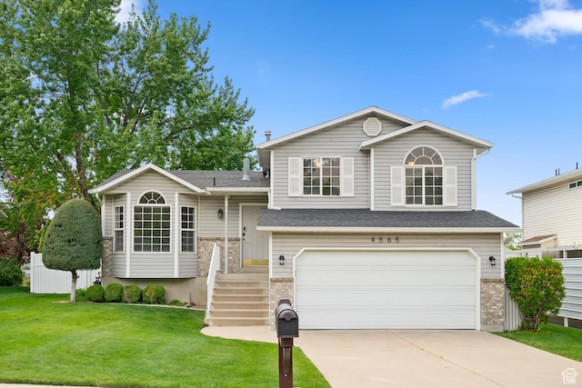 split level home with an attached garage, brick siding, driveway, and a shingled roof