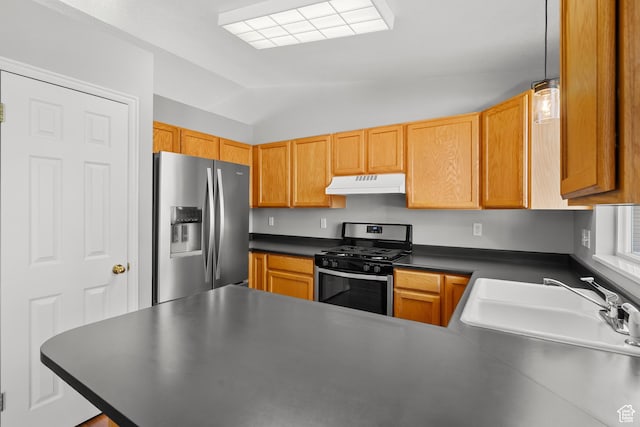 kitchen with stainless steel appliances, under cabinet range hood, a sink, dark countertops, and vaulted ceiling