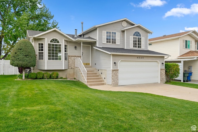 tri-level home with an attached garage and concrete driveway