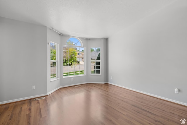 empty room with wood finished floors and baseboards