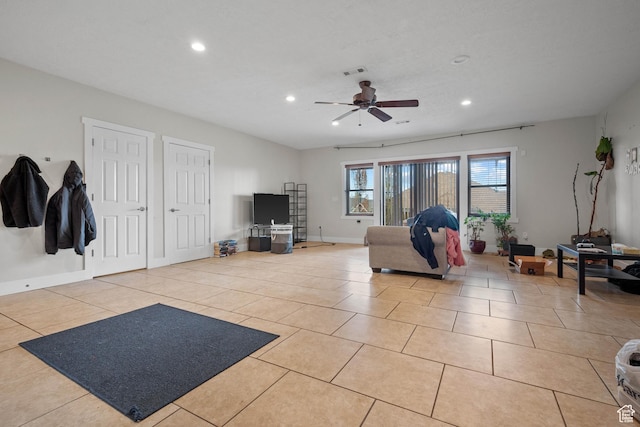living area featuring recessed lighting, ceiling fan, light tile patterned floors, and baseboards