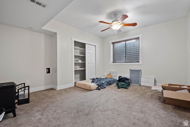 sitting room featuring carpet floors, ceiling fan, and baseboards
