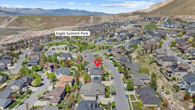 aerial view of property's location featuring nearby suburban area and a mountainous background