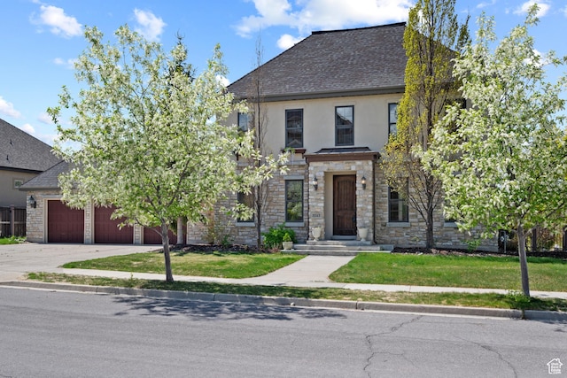 view of front of house featuring stucco siding, an attached garage, stone siding, driveway, and a shingled roof