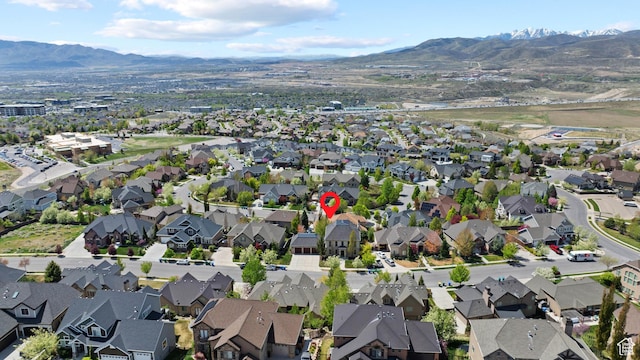 aerial view of property's location with nearby suburban area and a mountain backdrop