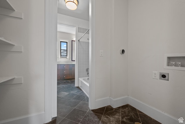 laundry room with hookup for an electric dryer, hookup for a washing machine, and baseboards