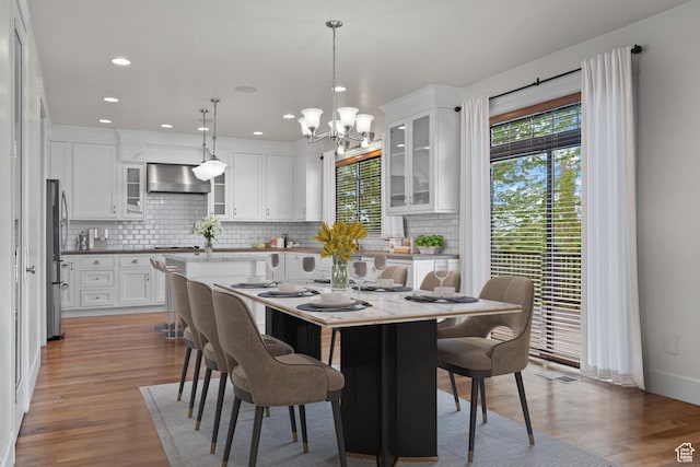 5047 N Larkwood Ln, Lehi, UT 84043 - dining area with a chandelier, wood finished floors, and recessed lighting