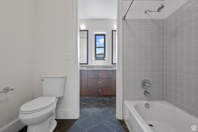 full bath with toilet, washtub / shower combination, baseboards, vanity, and tile patterned floors