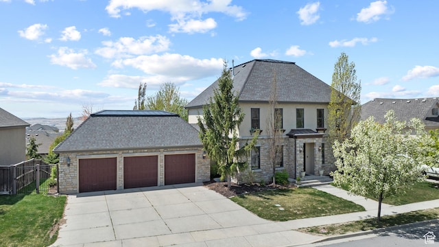 view of front of house featuring stone siding, concrete driveway, a garage, and stucco siding