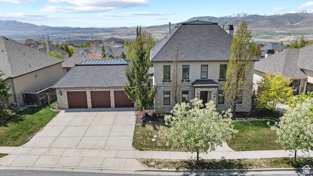view of front of home with a garage, driveway, a residential view, and stucco siding
