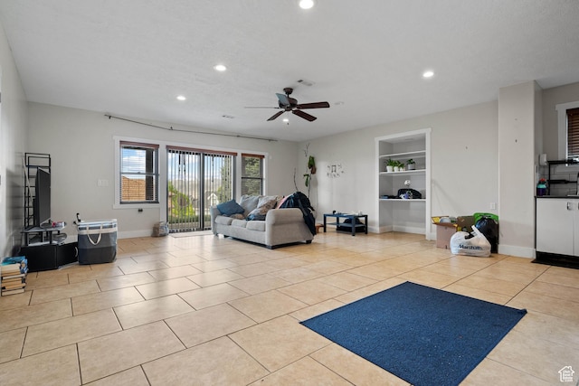 tiled living room featuring recessed lighting, a ceiling fan, built in features, and baseboards