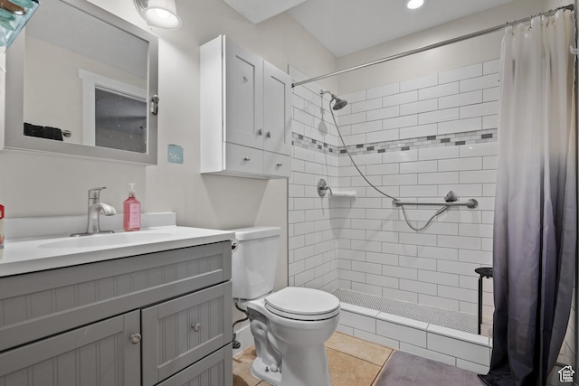 bathroom with a tile shower, toilet, vanity, recessed lighting, and tile patterned floors