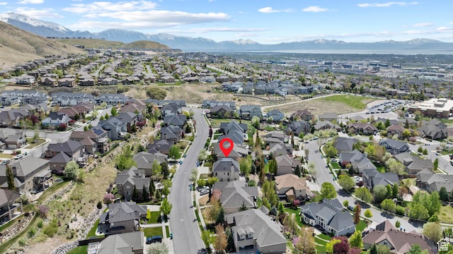 aerial view of property and surrounding area with nearby suburban area and mountains