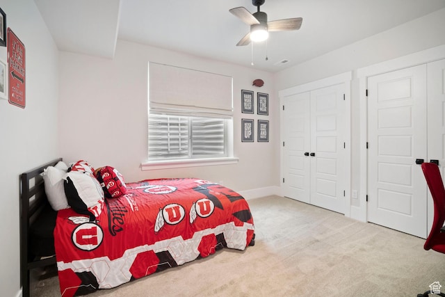 carpeted bedroom with a closet, ceiling fan, and baseboards