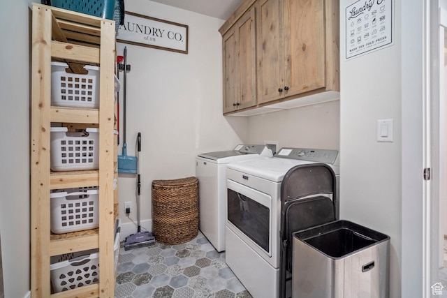 laundry area featuring cabinet space, washer and clothes dryer, and tile patterned flooring