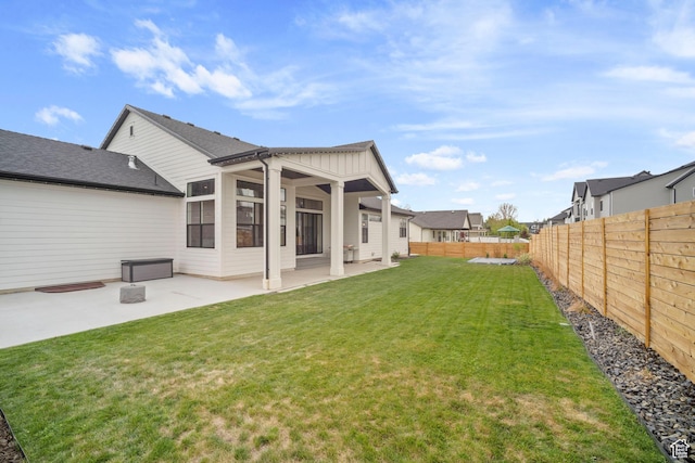 rear view of house with a patio area and board and batten siding
