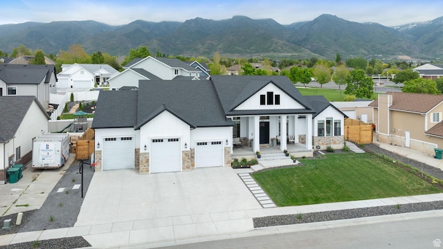 view of front of home with stone siding, an attached garage, a porch, and a shingled roof