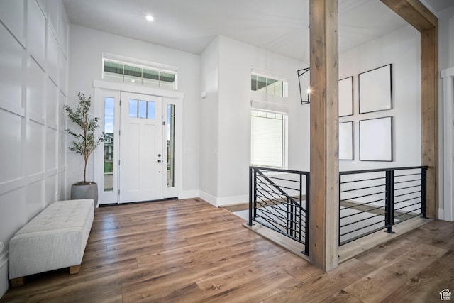 entryway with wood finished floors, baseboards, and recessed lighting
