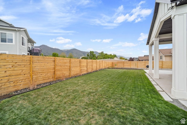 view of yard with a mountain view and a patio area