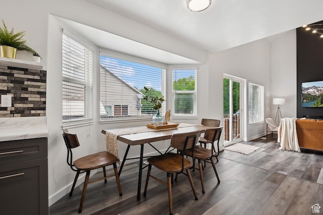 dining area with wood finished floors and baseboards