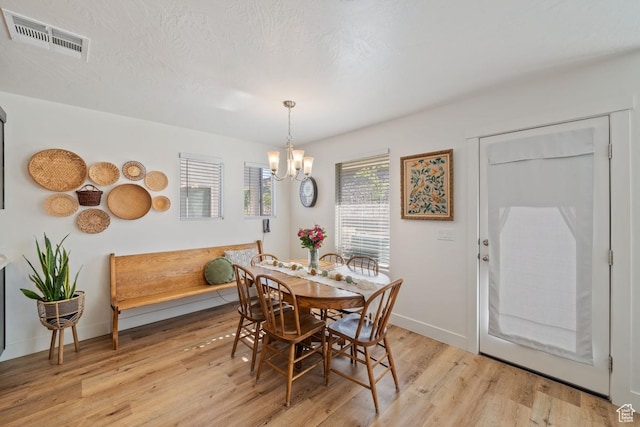6303 S Zelda Dr, St George, UT 84790 - dining space with a chandelier, light wood-style floors, and baseboards