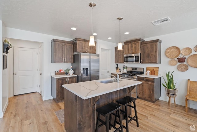 6303 S Zelda Dr, St George, UT 84790 - kitchen with appliances with stainless steel finishes, a sink, light wood-type flooring, baseboards, and recessed lighting
