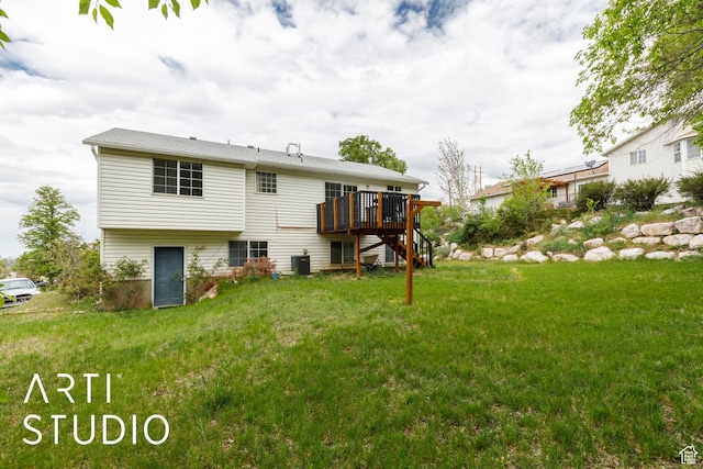 rear view of property with a wooden deck, a yard, stairs, and central AC