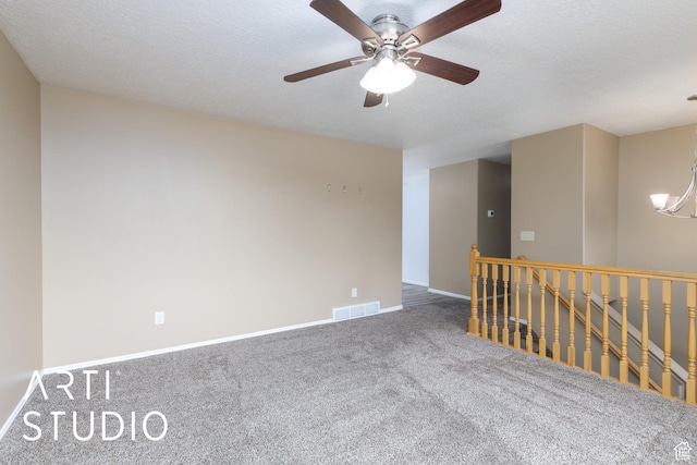spare room with carpet, baseboards, and ceiling fan