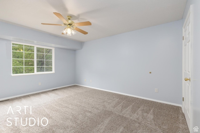 empty room with carpet flooring, ceiling fan, and baseboards