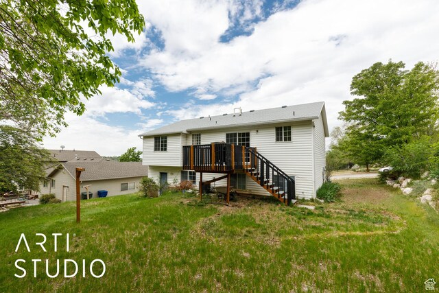 back of house featuring stairway, a wooden deck, and a yard