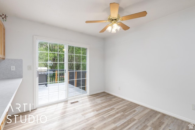 unfurnished room with light wood-style floors, ceiling fan, and baseboards