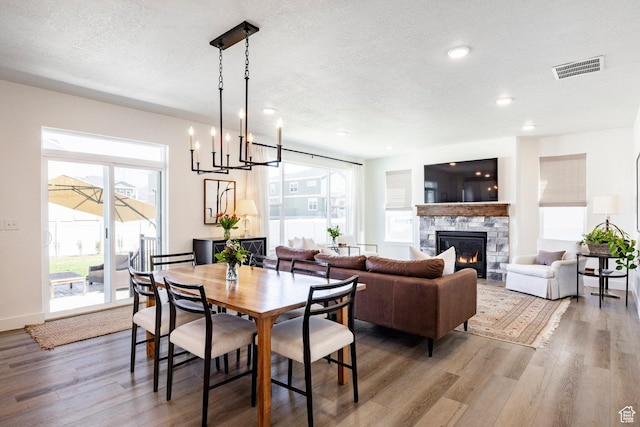 1401 S 1040 E, Heber City, UT 84032 - dining area featuring wood finished floors, a chandelier, a fireplace, recessed lighting, and a textured ceiling