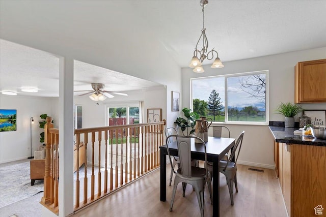 155 W 1525 N, Layton, UT 84041 - dining area with light wood-style flooring, baseboards, ceiling fan, and a chandelier