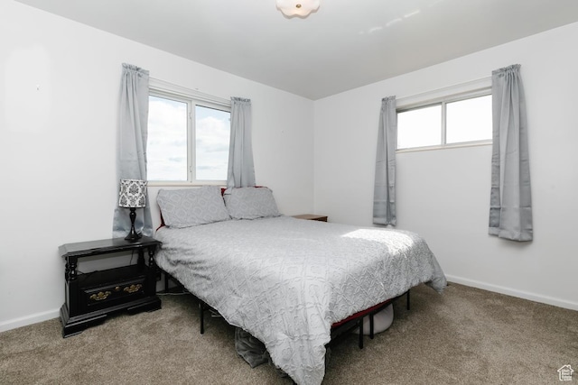 carpeted bedroom featuring baseboards