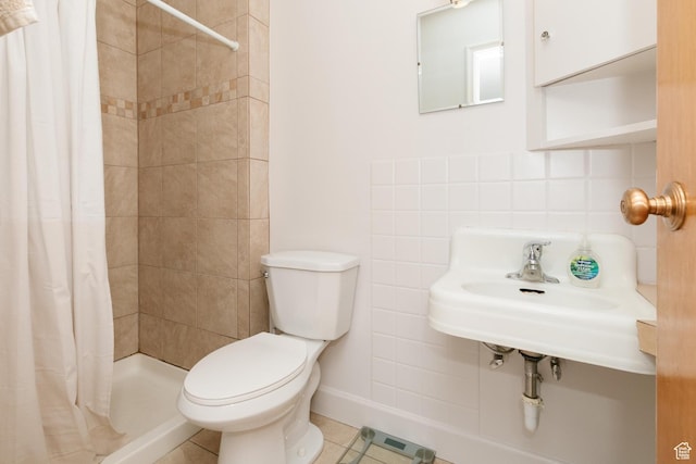 full bathroom with toilet, a shower stall, decorative backsplash, tile patterned floors, and baseboards