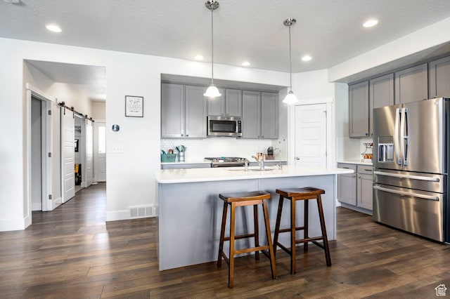 4468 W Meadow Bend Dr S, Herriman, UT 84096 - kitchen featuring appliances with stainless steel finishes, gray cabinetry, a sink, light countertops, and backsplash