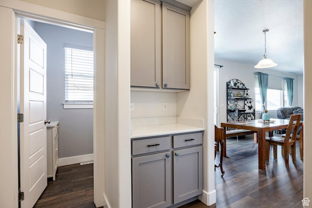 4468 W Meadow Bend Dr S, Herriman, UT 84096 - kitchen featuring gray cabinetry, dark wood-type flooring, light countertops, and pendant lighting
