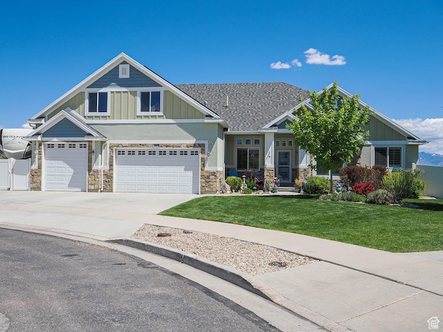 7503 S Bridge Maple Ln, West Jordan, UT 84081 - craftsman-style house featuring stone siding, a front yard, driveway, and board and batten siding