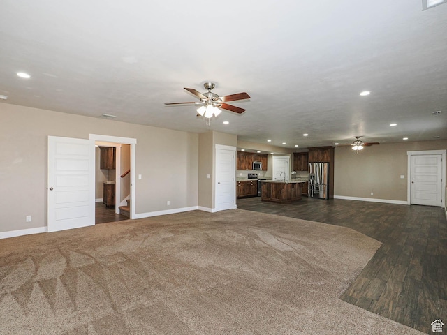 7503 S Bridge Maple Ln, West Jordan, UT 84081 - unfurnished living room featuring ceiling fan, baseboards, recessed lighting, and stairs