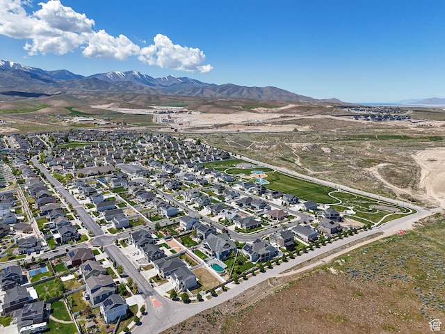 7503 S Bridge Maple Ln, West Jordan, UT 84081 - aerial view of property and surrounding area with a mountainous background and nearby suburban area
