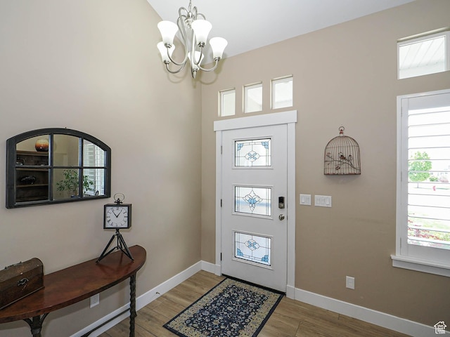7503 S Bridge Maple Ln, West Jordan, UT 84081 - entryway featuring a chandelier, light wood-type flooring, and baseboards