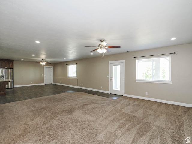 7503 S Bridge Maple Ln, West Jordan, UT 84081 - unfurnished living room with a ceiling fan, recessed lighting, dark carpet, and baseboards