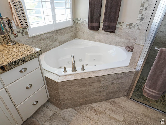 7503 S Bridge Maple Ln, West Jordan, UT 84081 - bathroom with a tub with jets and vanity