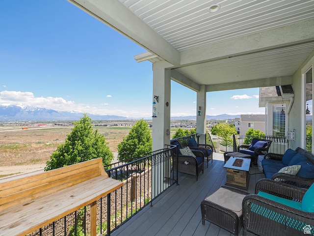 7503 S Bridge Maple Ln, West Jordan, UT 84081 - wooden deck featuring an outdoor living space with a fire pit and a mountain view