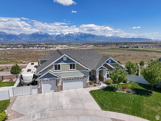 7503 S Bridge Maple Ln, West Jordan, UT 84081 - craftsman inspired home with stone siding, board and batten siding, a mountain view, concrete driveway, and an attached garage