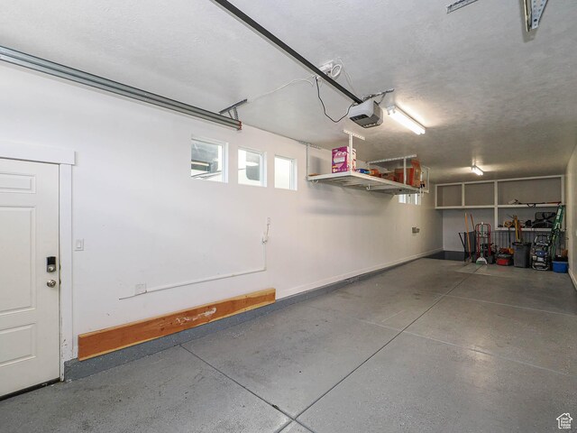 7503 S Bridge Maple Ln, West Jordan, UT 84081 - garage featuring baseboards and a garage door opener