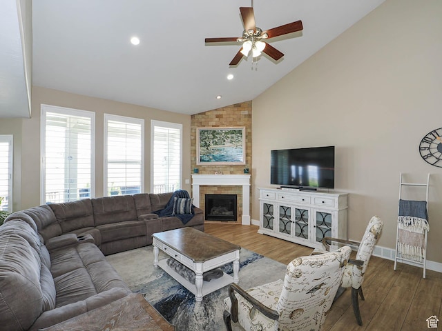 7503 S Bridge Maple Ln, West Jordan, UT 84081 - living area with a ceiling fan, vaulted ceiling, wood finished floors, baseboards, and a fireplace