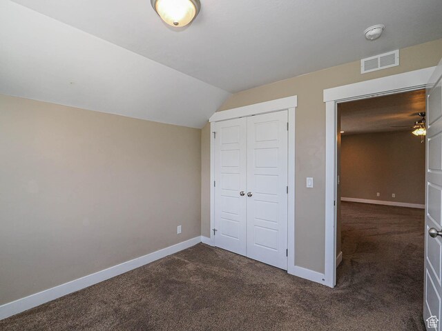 7503 S Bridge Maple Ln, West Jordan, UT 84081 - unfurnished bedroom with dark colored carpet, baseboards, a closet, and vaulted ceiling
