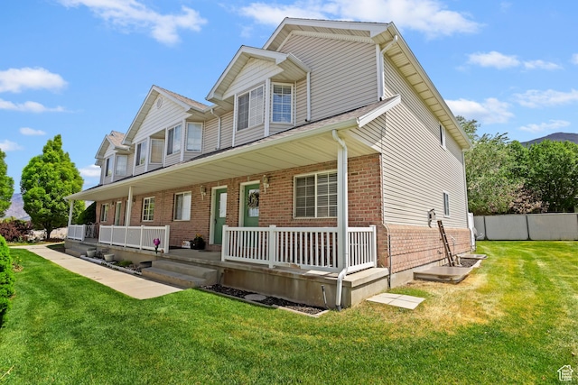 view of front facade featuring covered porch and brick siding