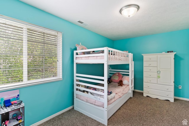 carpeted bedroom with multiple windows and baseboards